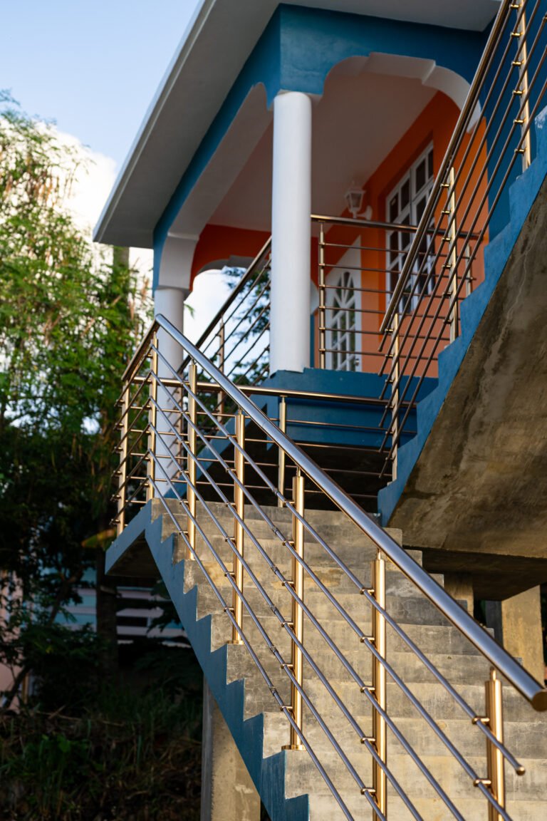 Stainless steel stair railing installation on modern residential home with polished horizontal bars and clean finish