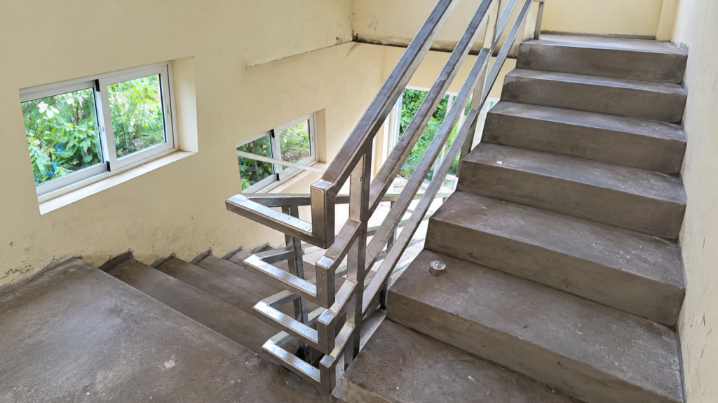 Custom steel stair railing with geometric detailing, designed and built by Progressive Welding Solutions.